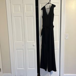 Black jumpsuit, somewhat open back
